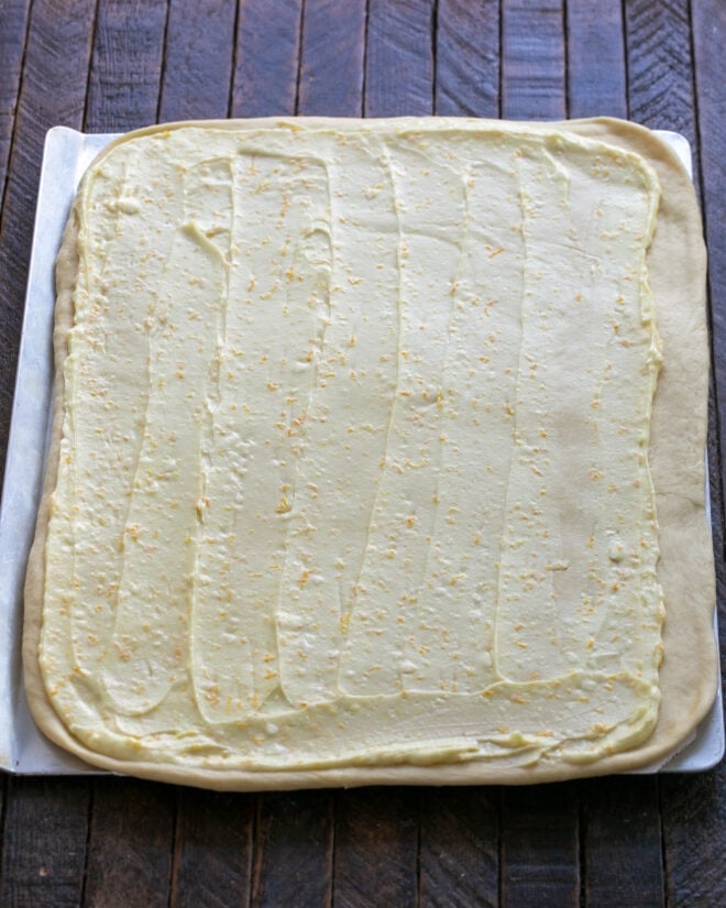 Half of the orange filling spread over dough.