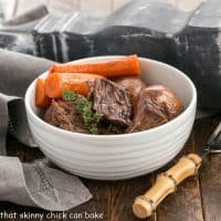 Pressure Cooker Beef stew in a white bowl with a bamboo handled fork