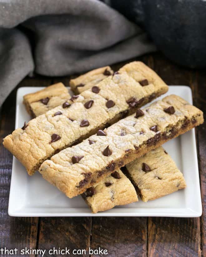 4 chocolate chip cookie sticks on a square white plate