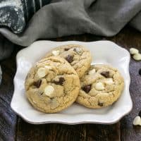 3 chocolate chip cookies with pudding on a square white plate