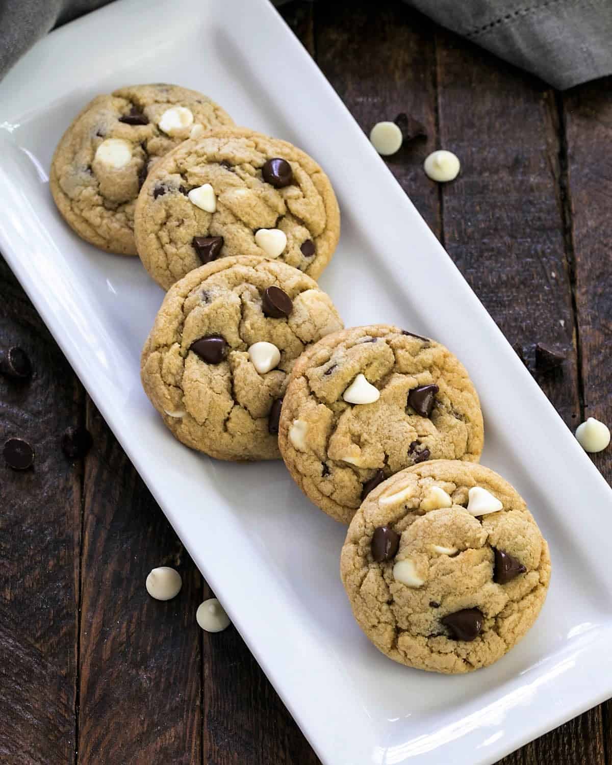 Overhead view of soft chocolate chip cookies on a white tray.