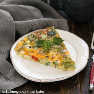 Roasted Broccoli Frittata slice on a round white plate