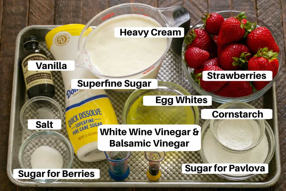 Strawberry Pavlova Ingredients with labels on a metal sheetpan.
