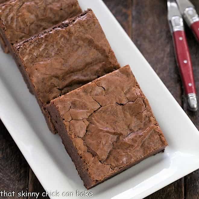 Closeup of Fudgy brownies on a white tray.