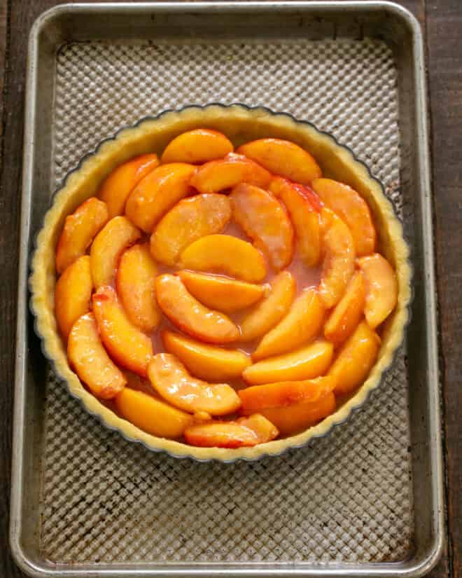 Peach slices arranged in tart shell.