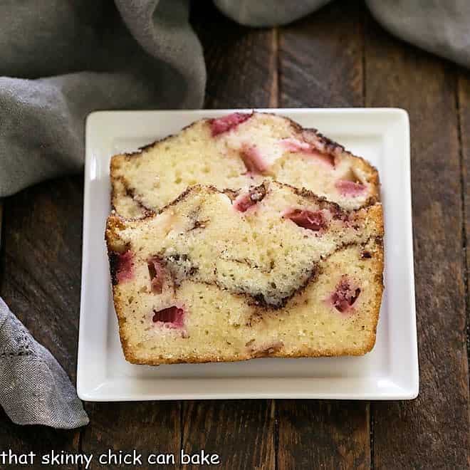 2 slices of rhubarb bread on a square white plate.