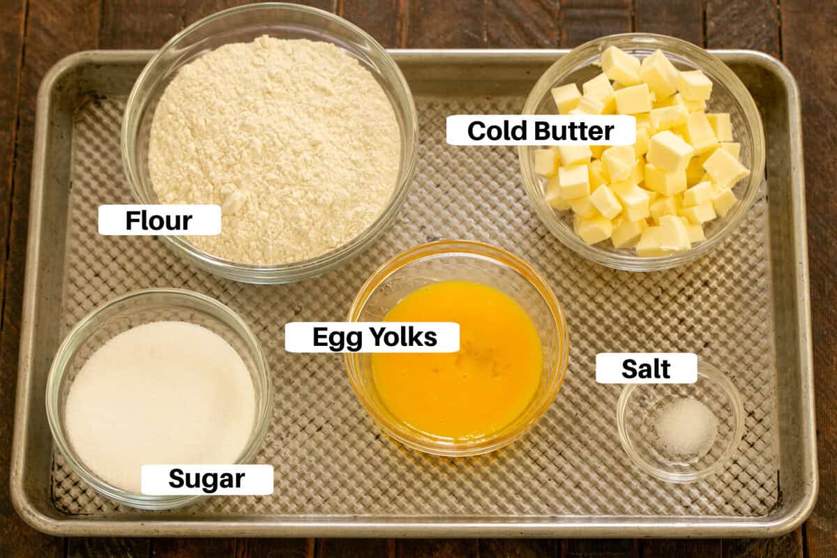 Peach tart crust ingredients with labels on a metal sheetpan.