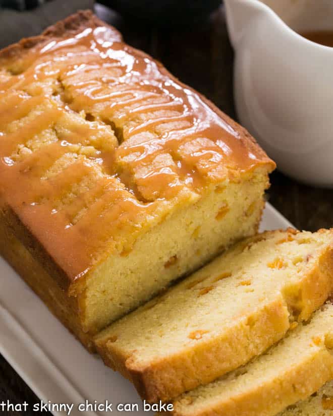 Glazed Peach Pound Cake sliced on a white tray.