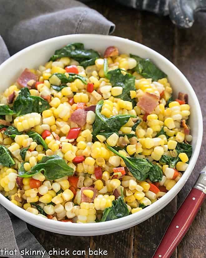 Overhead view of skillet corn in a white bowl.