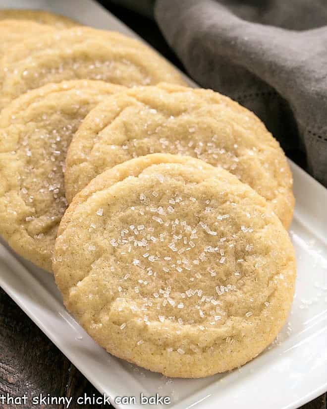 Staggered sugar cookies on a white tray.