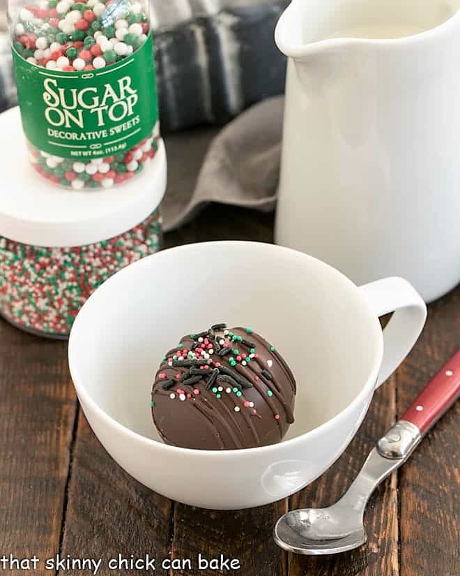 A hot chocolate bomb in a cup.