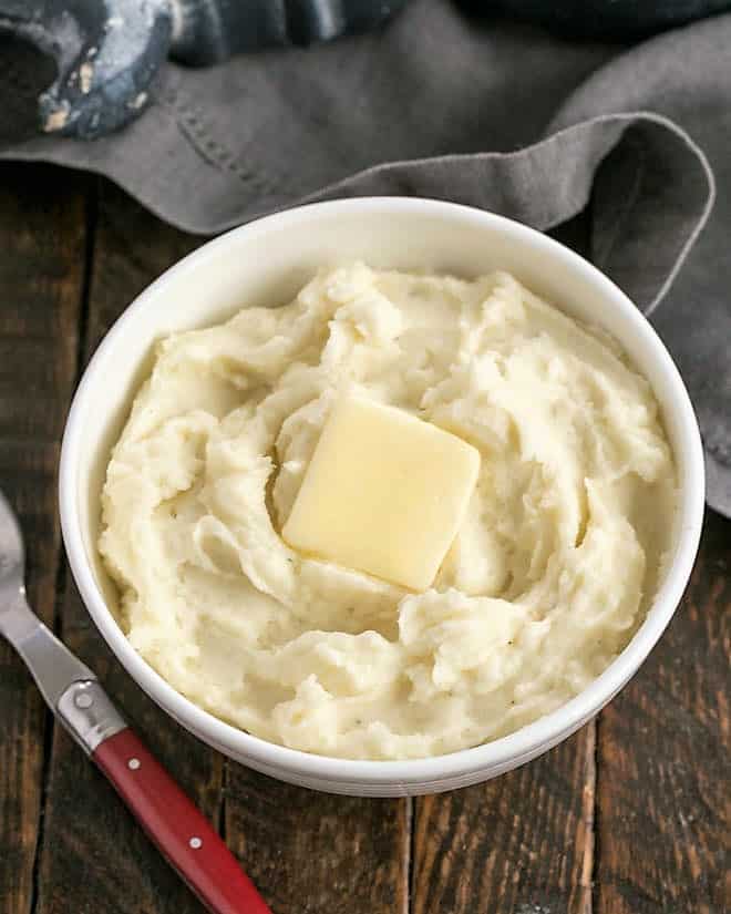 Creamy Mashed Potatoes infused with butter, cream and cream cheese for a rich holiday or special occasion side dish! Overhead view of creamy mashed potatoes