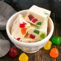 Small white bowl with fudge squares surrounded by gumdrops