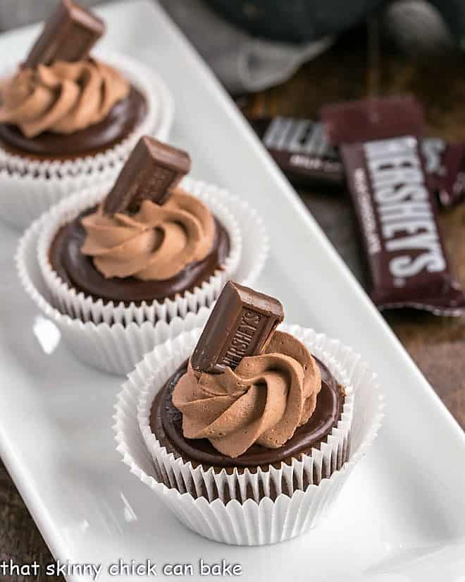 White tray of mini chocolate cheesecakes.