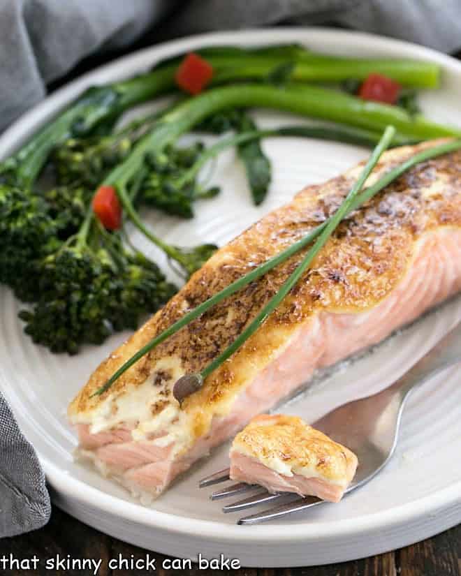 Roasted salmon on a plate with a bite on a fork