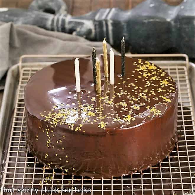 Process of Making and glazing a mirror cake on a cooling rack over a sheet pan.