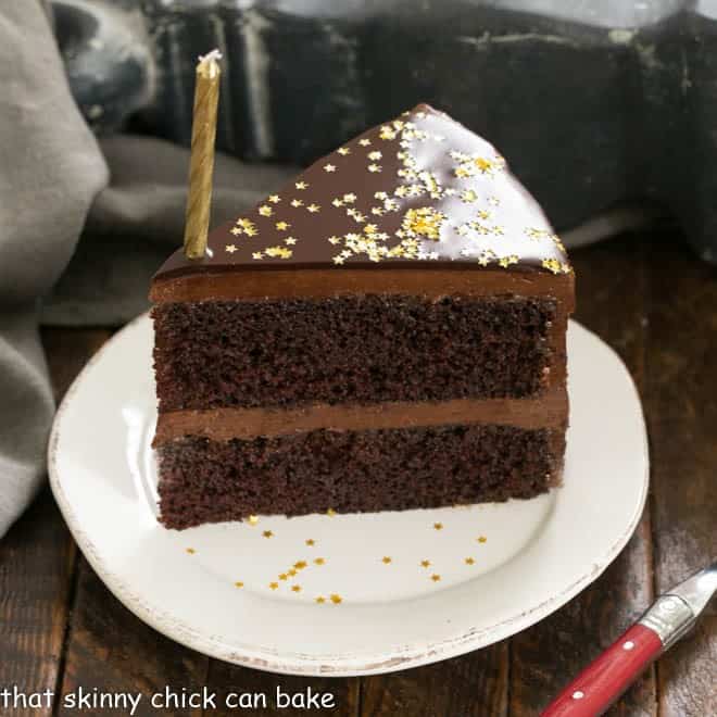 A slice of chocolate mirror cake on a white dessert plate