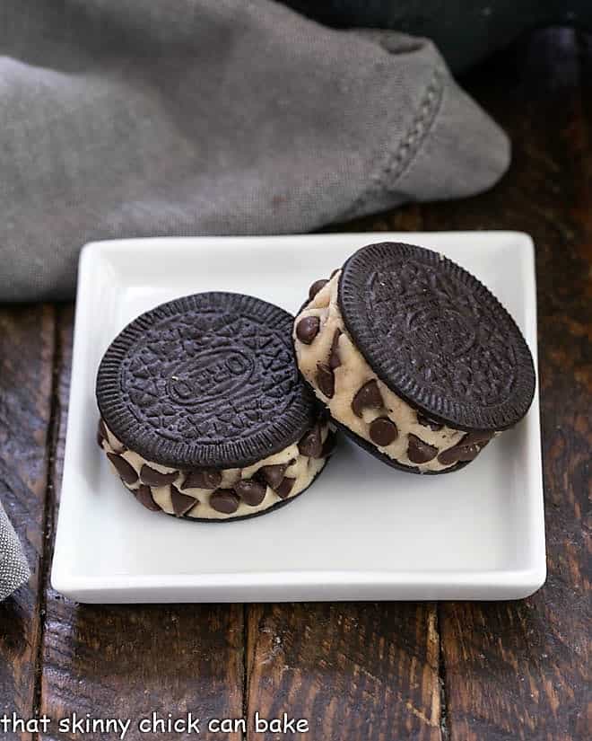 2 cookie dough stuffed Oreos on a square white plate.