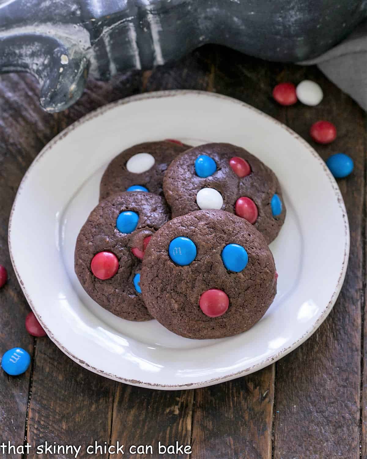4 patriotic brownie cookies on a round white plate.