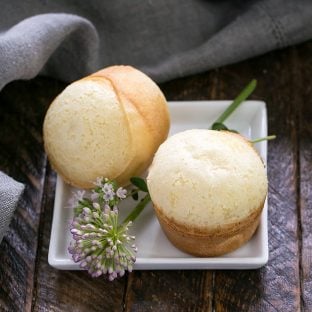 2 Brazilian Cheese Bread on a square white plate