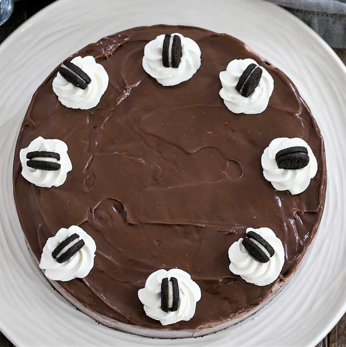 Chocolate Ice Cream Pie with an Oreo crust, chocolate ice cream and a fudge sauce topping! Perfect summer dessert.