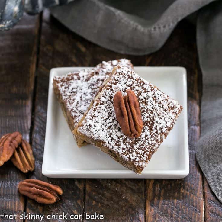 2 pecan bars on a small square plate