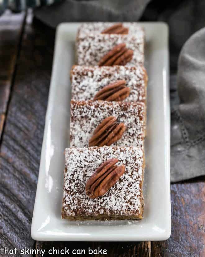 Pecan squares lined up on a white tray