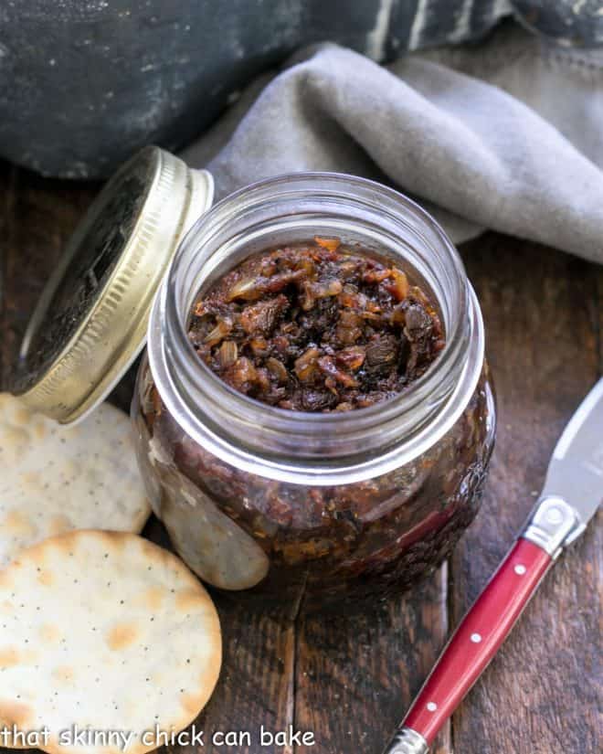 a jar of baon jame with crackers and a red handled knife