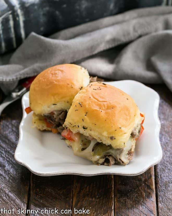 Two slider sandwiches on a small white ceramic plate