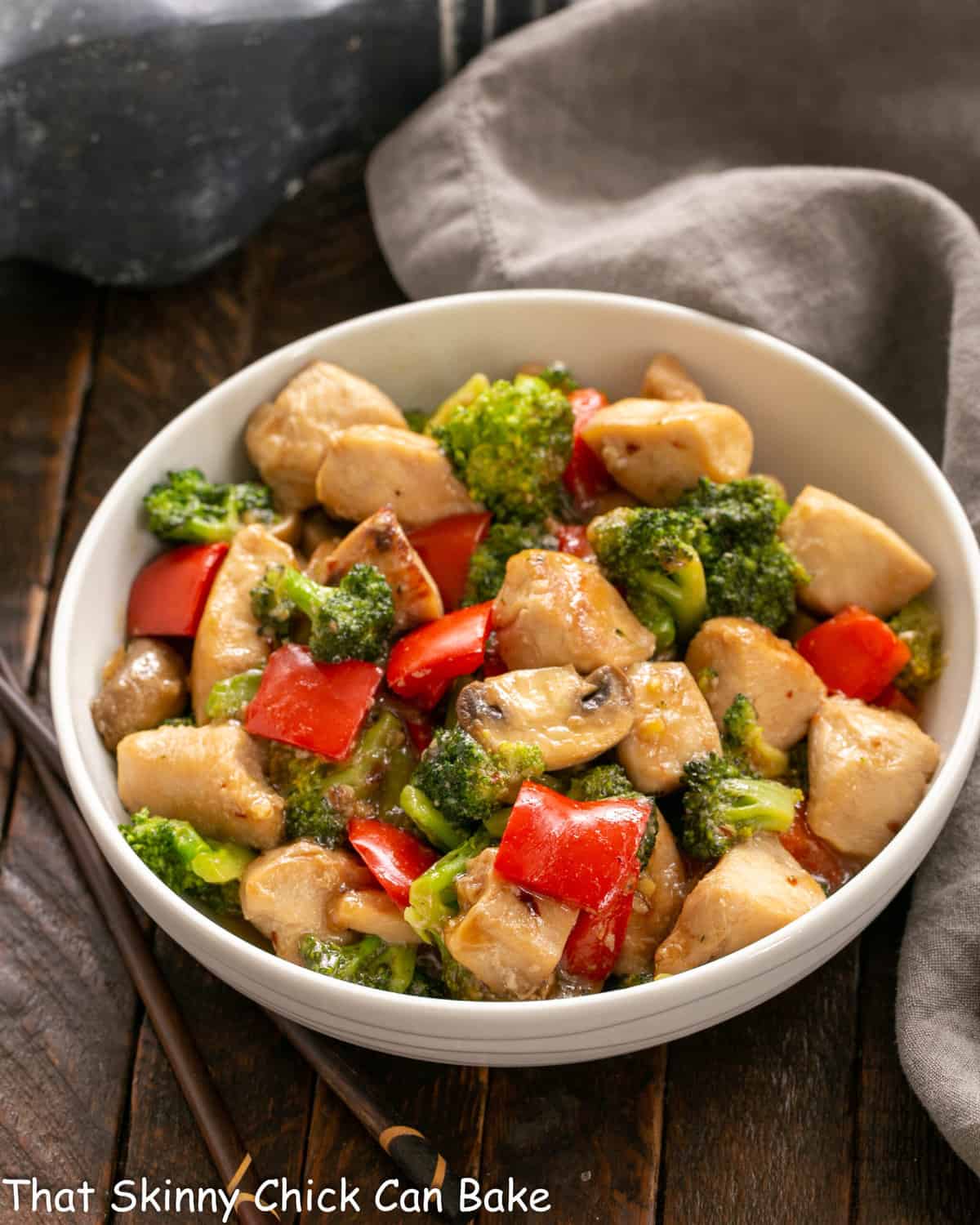 Chicken, Broccoli and Bell Pepper Stir Fry - an easy, flavorful dinner recipe that's family friendly and delicious! Chicken Broccoli Stir Fry in a white ceramic serving bowl.