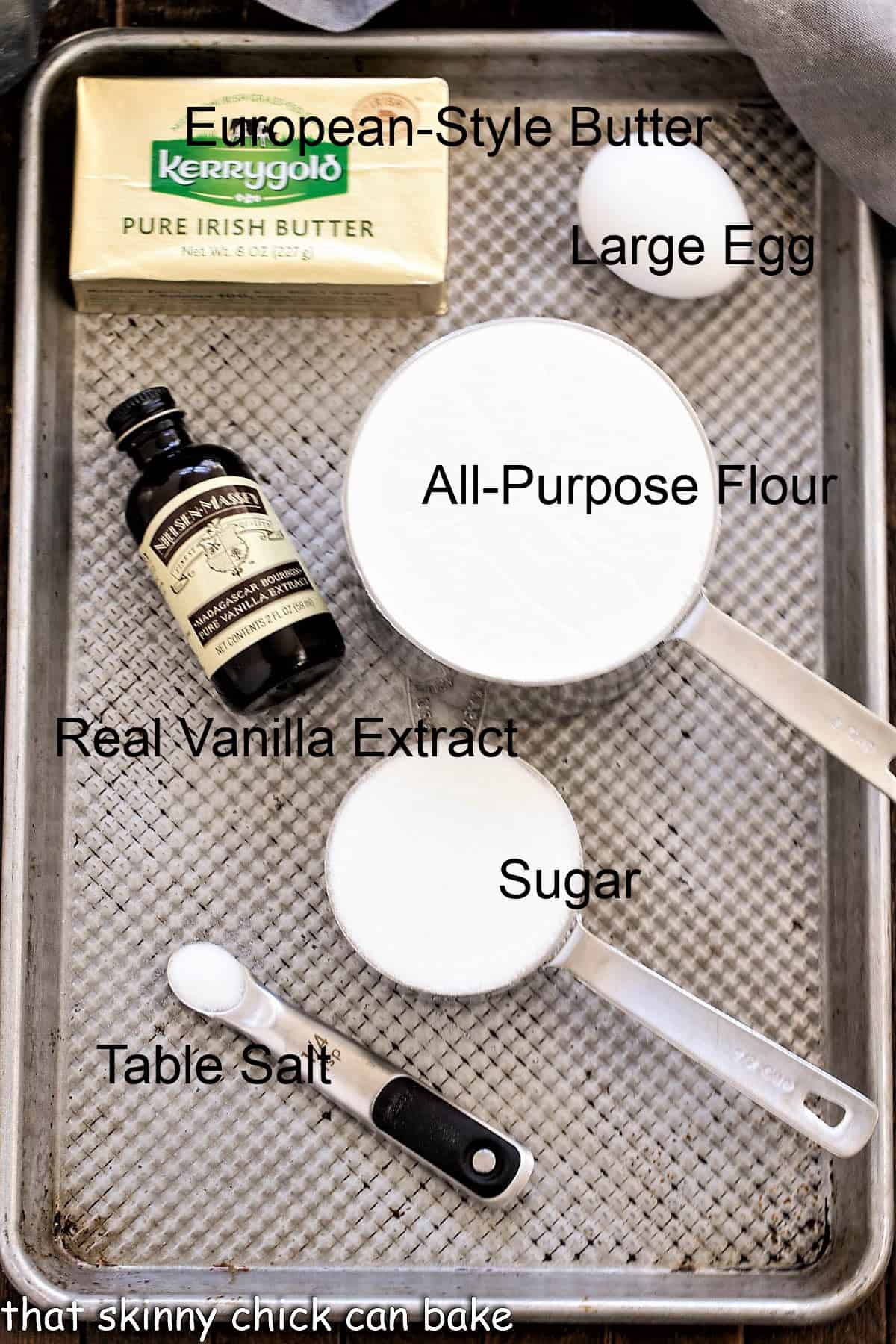 Ingredients for Danish butter cookies on a metal tray with labels.