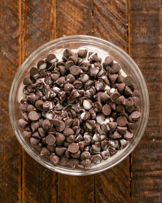 Chocolate chips with heavy cream in a bowl.