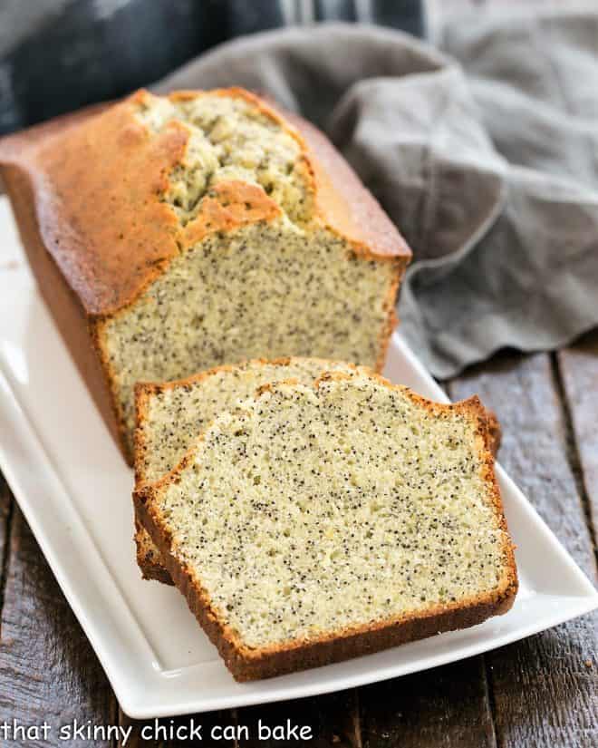 Sliced lemon poppy seed loaf on a ceramic tray