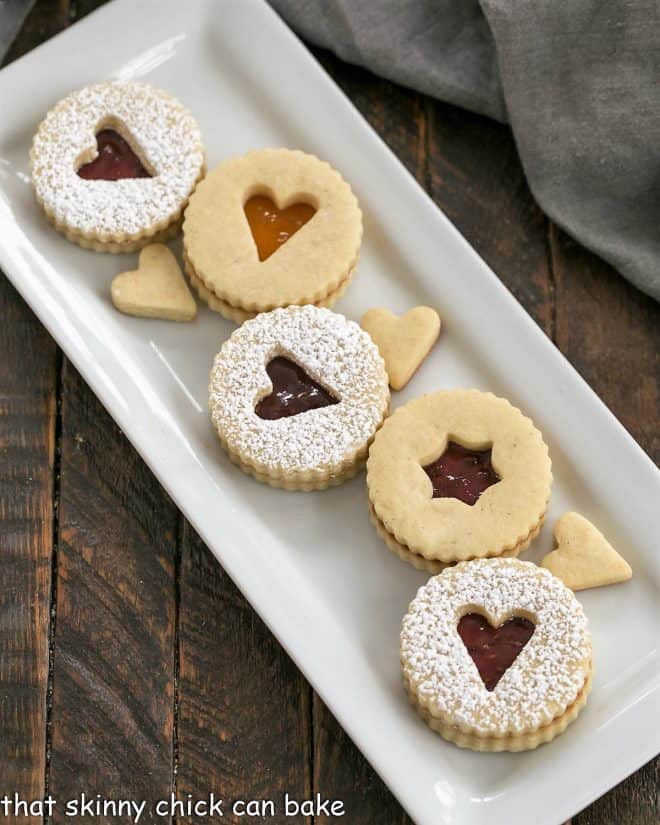 Overhead view of linzer cookies on a white ceramic tray