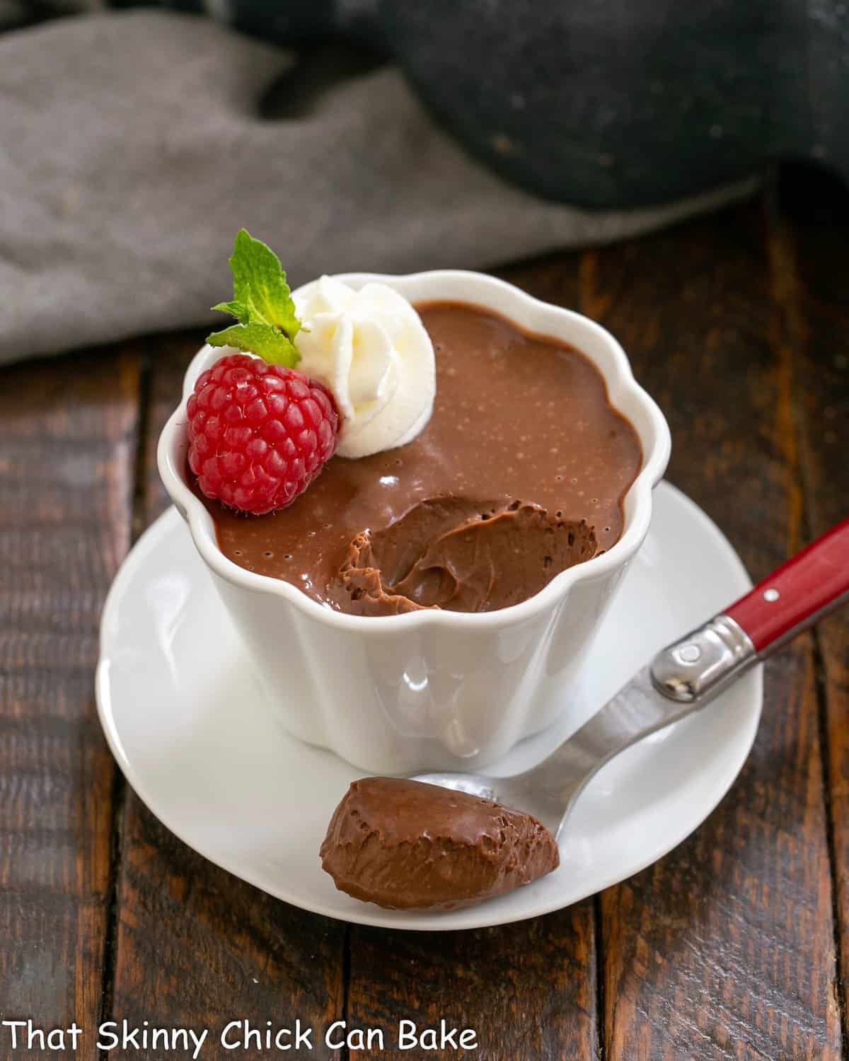 Irish cream pots de creme in a white ramekin with a spoonful removed.