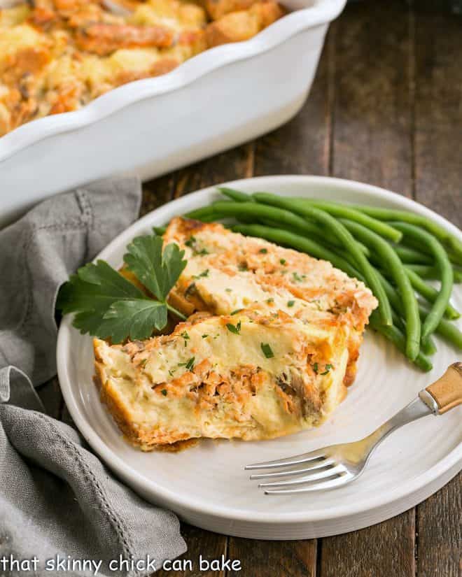 two slices of salmon loaf on a white plate with green beans