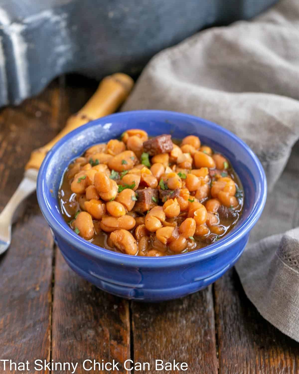 Blue ceramic bowl filled with homemade baked beans.