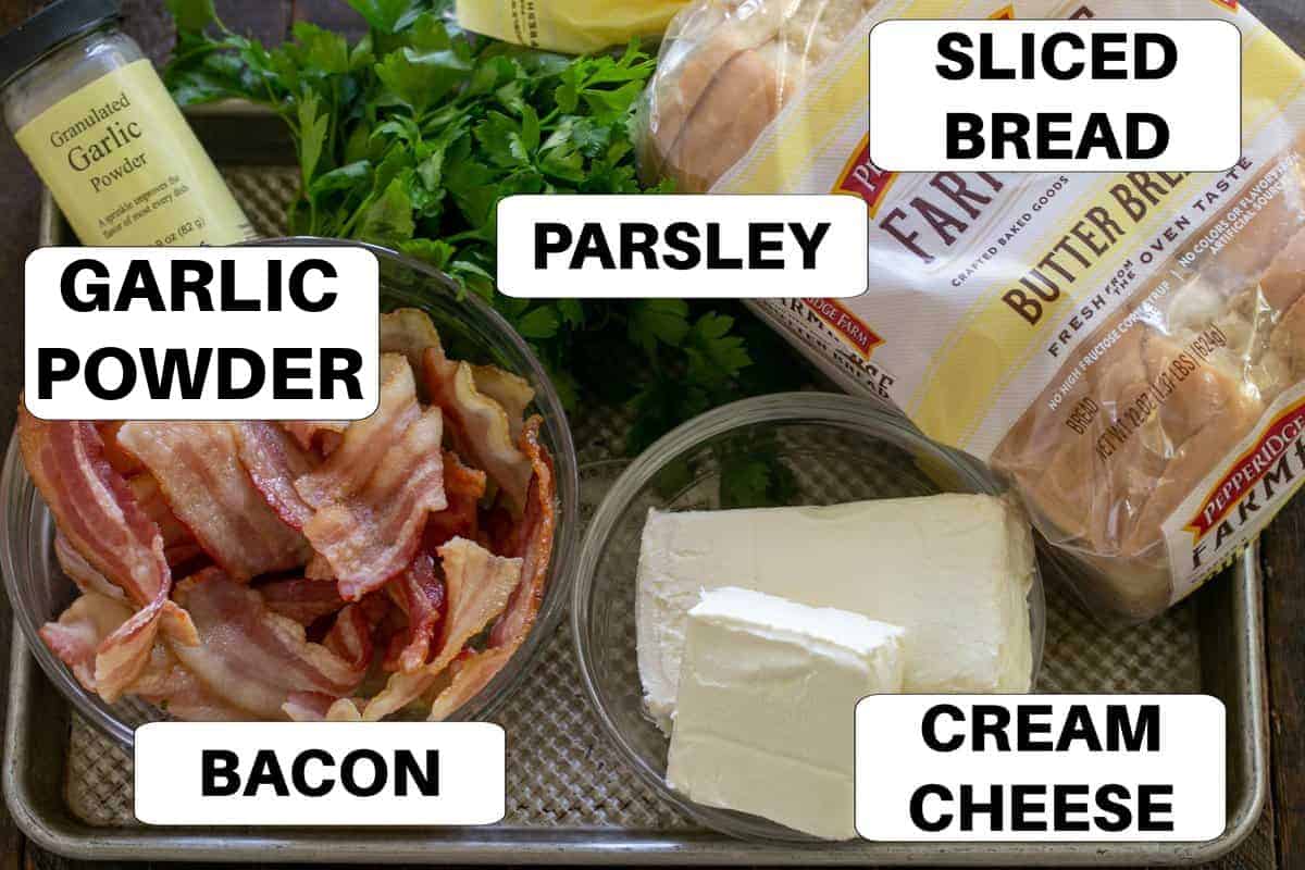 Bacon roll-ups ingredients with labels on a sheet pan.
