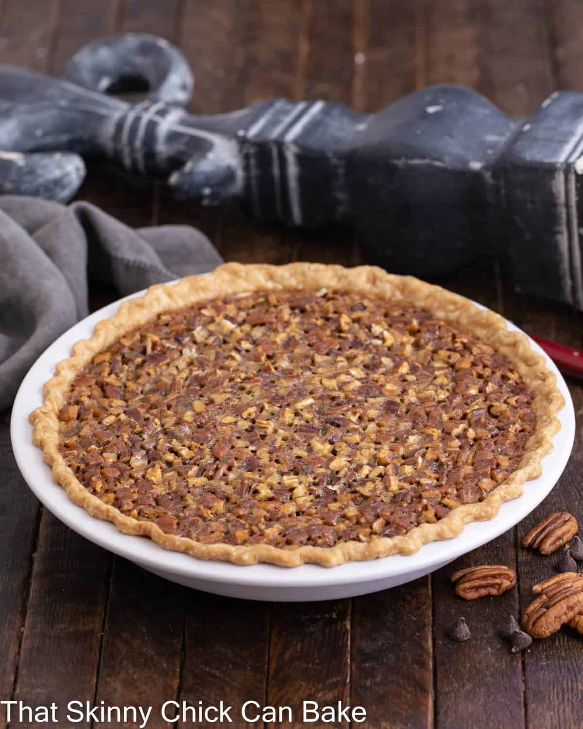 Side view of whole, uncut chocolate pecan pie recipe.