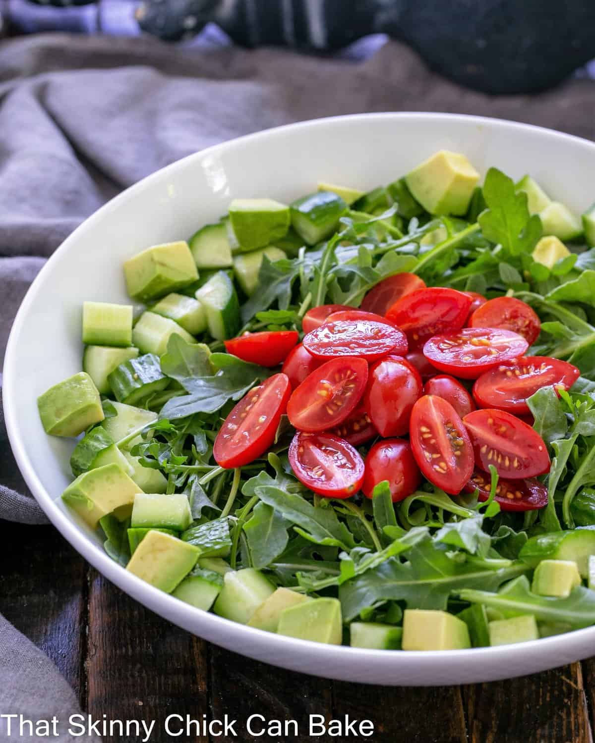 Rocket salad in a white serving bowl.