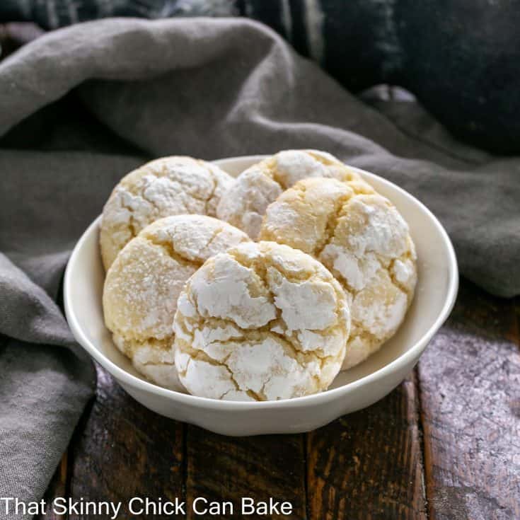 5 gooey butter cake cookies in a small white ceramic bowl.