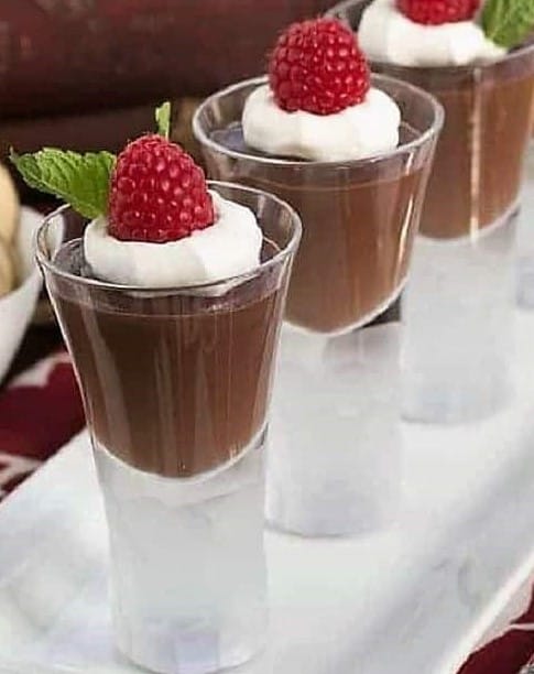 Garnished double chocolate pudding on a white tray.