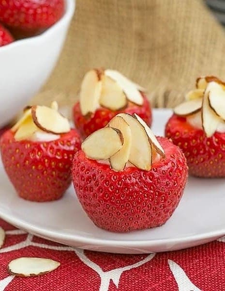 Stuffed strawberries on a small white plate.