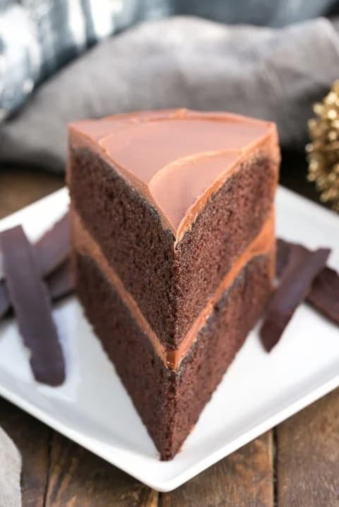 Slice of chocolate mayonnaise cake on a white plate.