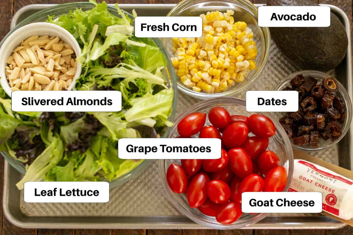 Macho Salad ingredients with labels on a sheet pan.
