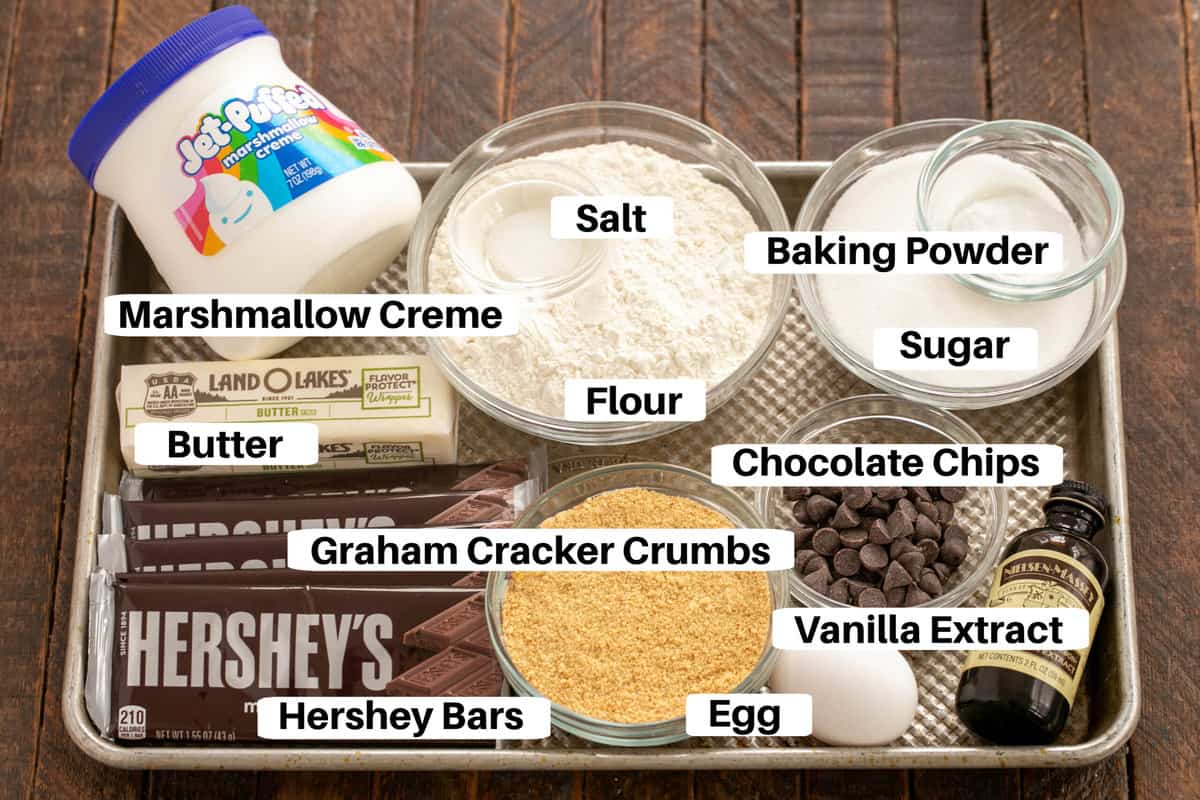 S'mores bars ingredients on a baking sheet with labels.
