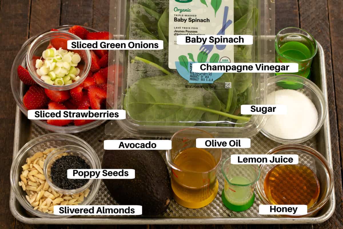 Spinach and Strawberry Salad with Avocados Ingredients on a sheet pan with labels.