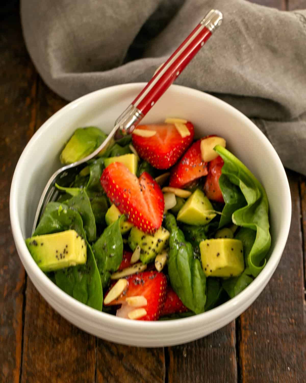 Overhead view of salad in a white salad bowl.