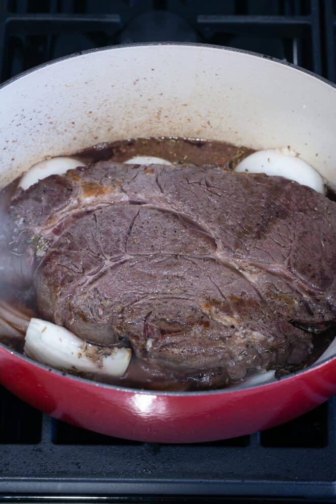 Pot roast cooking with onions.