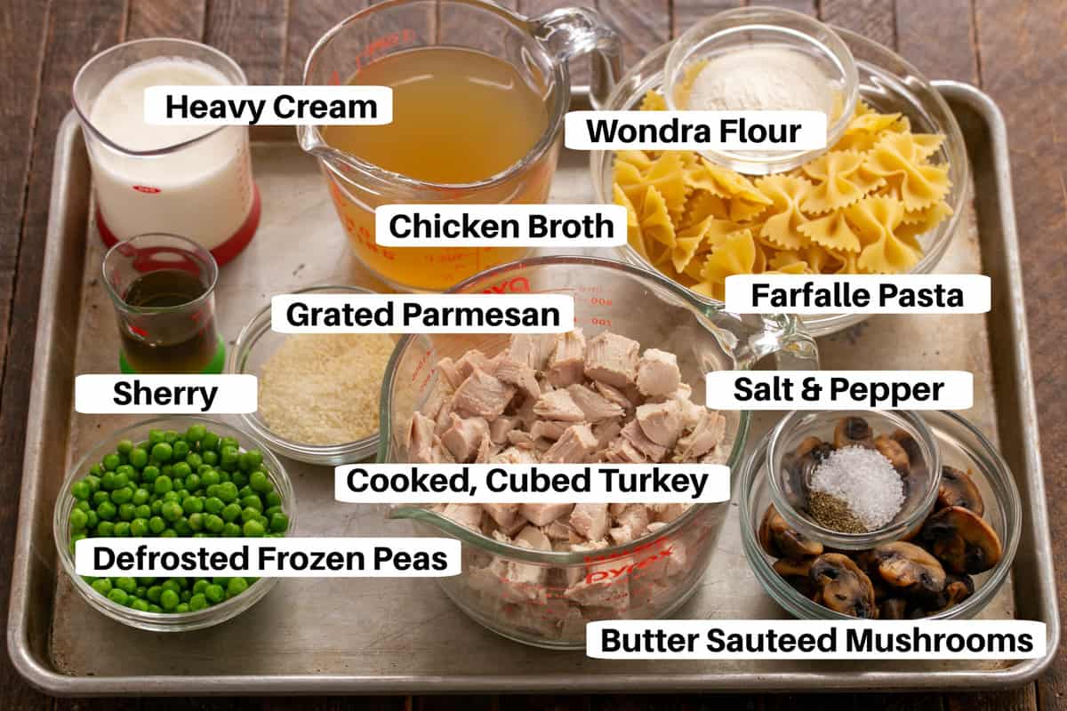 Tetrazzini ingredients with labels on a metal sheetpan.